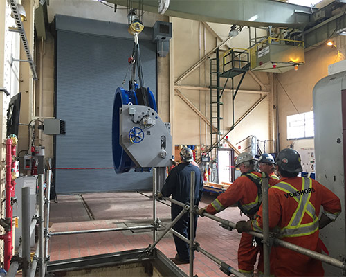 PREPARING TO LOWER ONE OF THE TWO NEW 25-TON BUTTERFLY VALVES INTO POSITION
